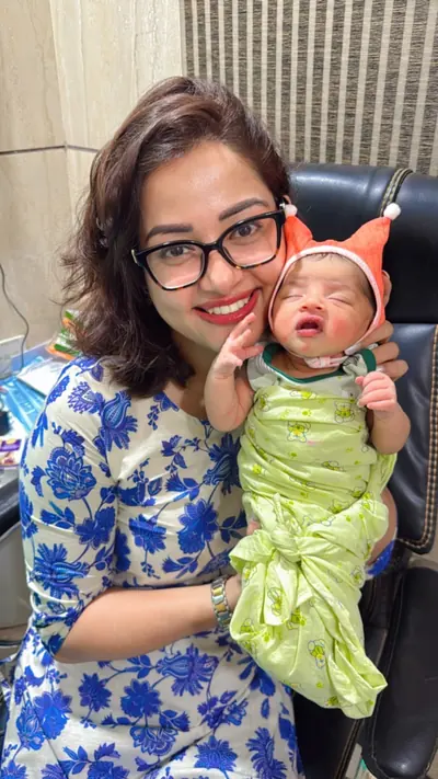Dr. Deepika Rawat holding a swaddled newborn